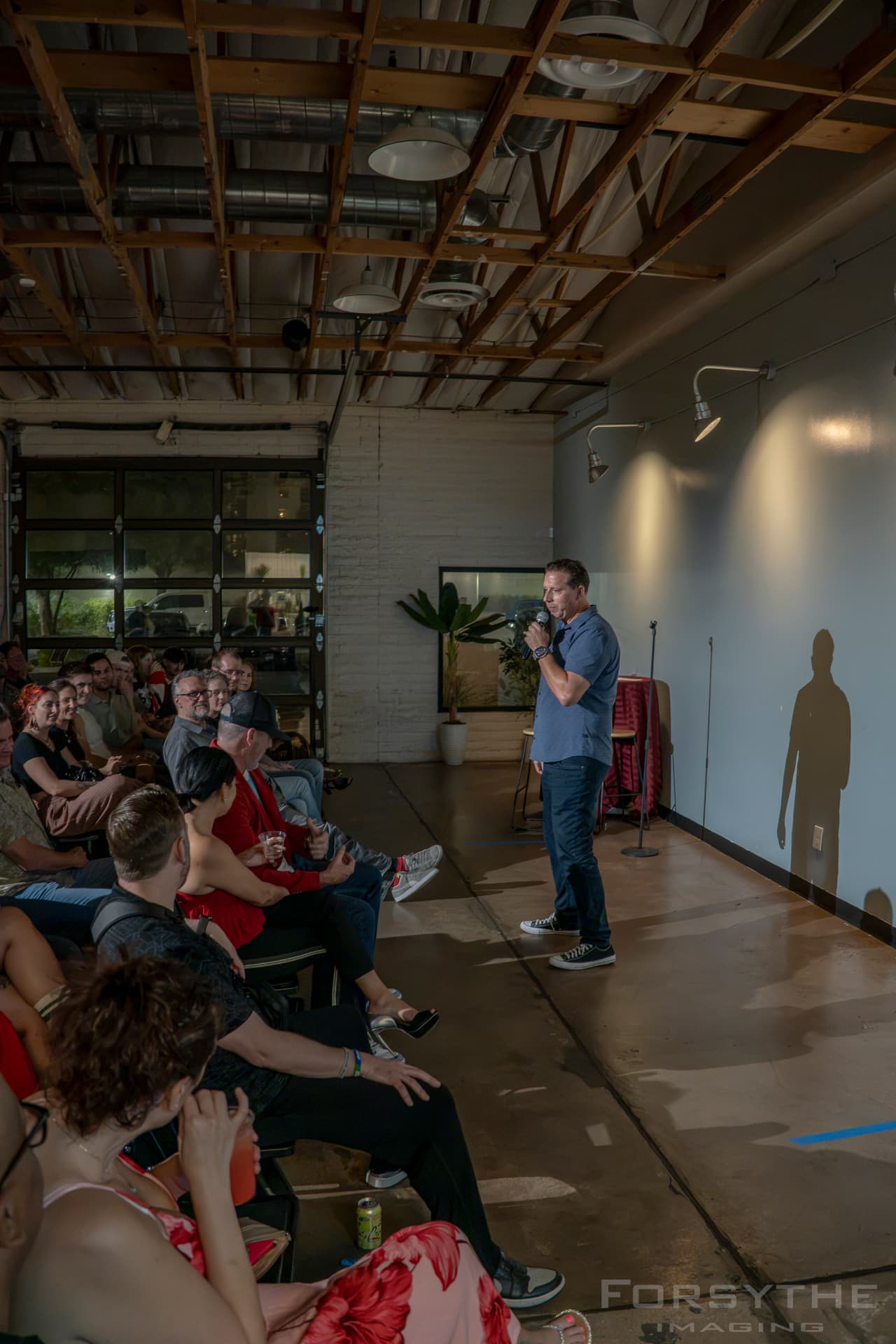 A speaker facing a live audience in the room