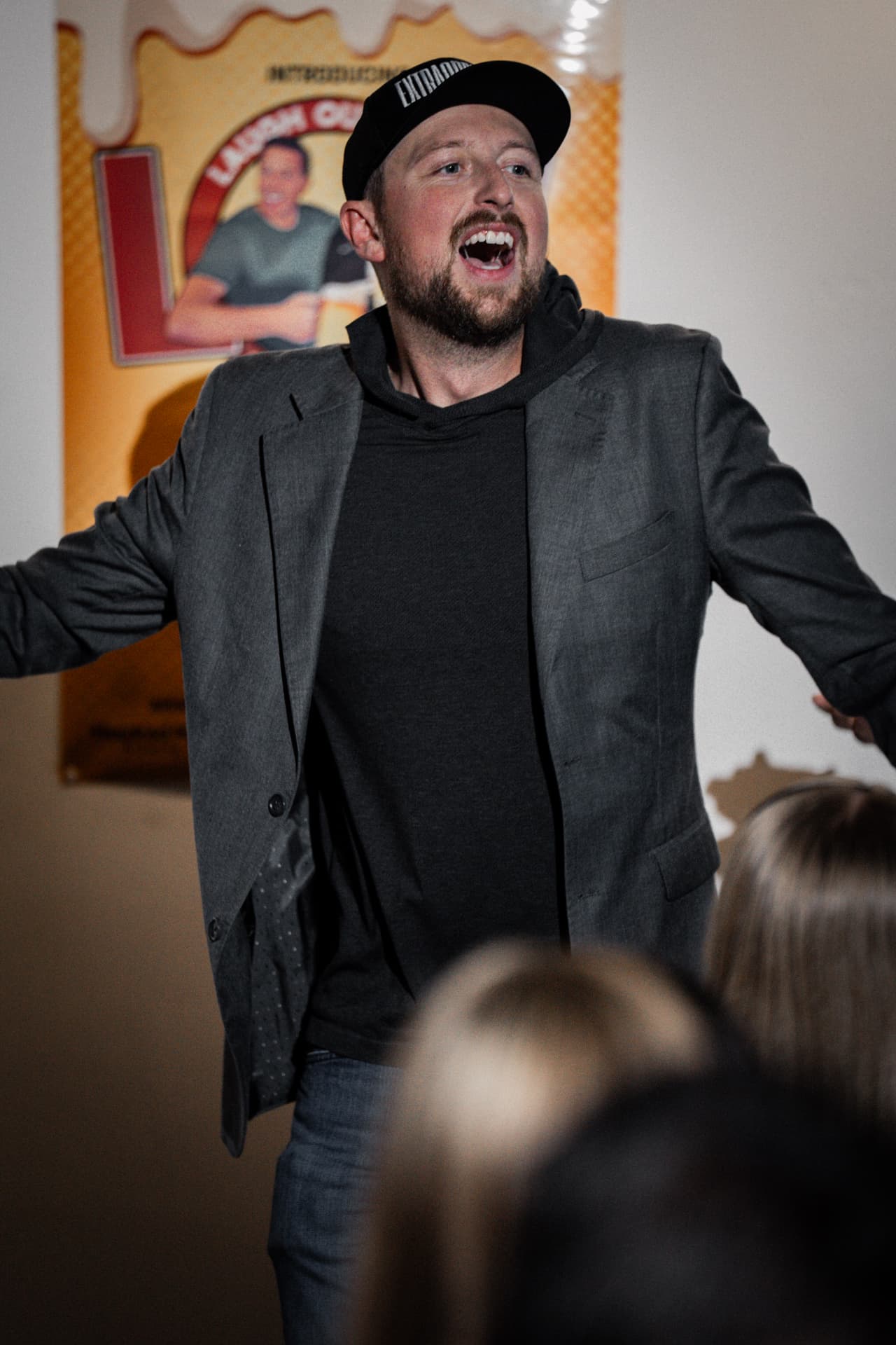 Aaron Bare speaking animatedly to a live audience