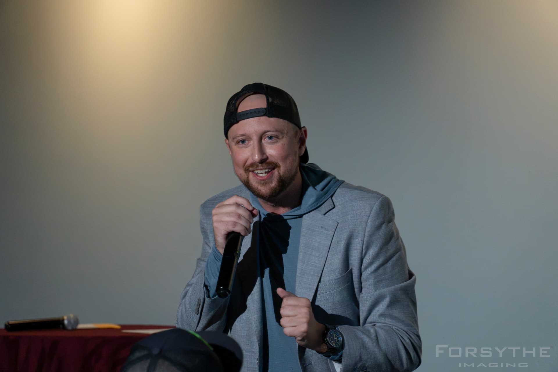 A host speaking into a microphone during the live show